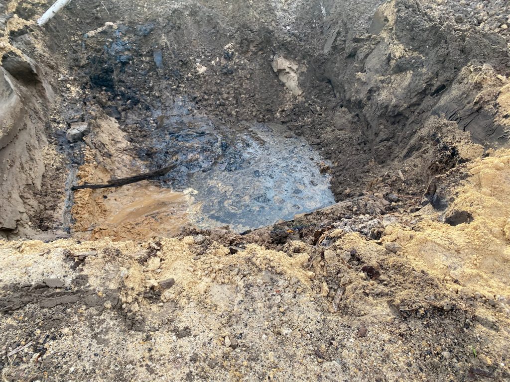 A hole in the ground where an underground storage tank was removed